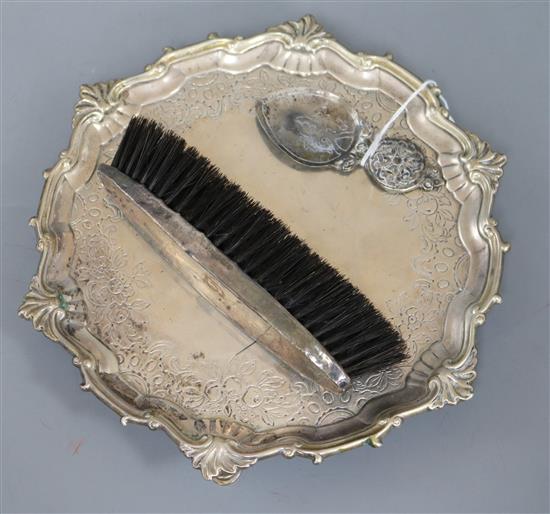 A silver Ionian caddy spoon, a silver backed brush and a waiter